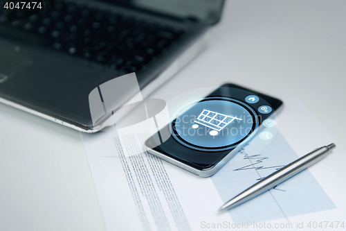 Image of close up of smartphone with shopping cart icon