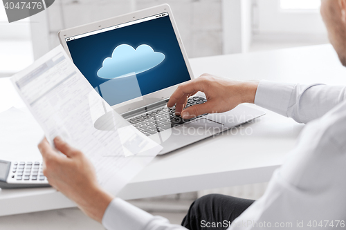 Image of businessman with laptop computer working at office