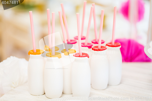 Image of close up of bottles with drinks and straws