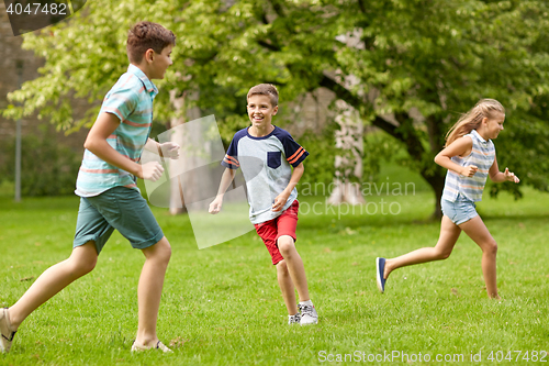 Image of happy kids running and playing game outdoors