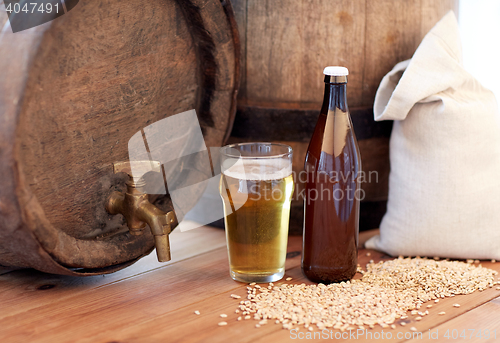 Image of close up of beer barrel, glass, bottle and malt