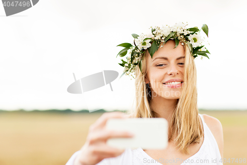 Image of happy young woman taking selfie by smartphone