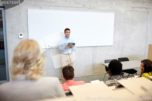 Image of students and teacher with tablet pc at lecture