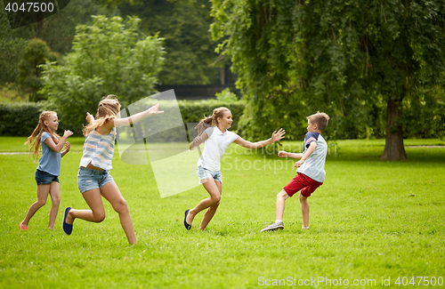 Image of happy kids running and playing game outdoors