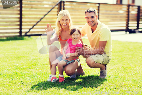 Image of happy family hugging outdoors