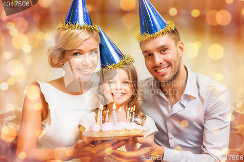 Image of smiling family in blue hats with cake