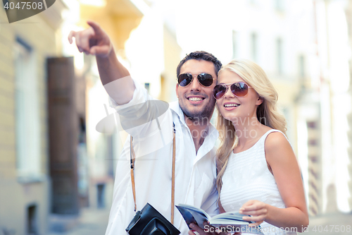 Image of couple with map, camera and travellers guide