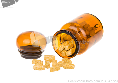 Image of Open bottle and pills