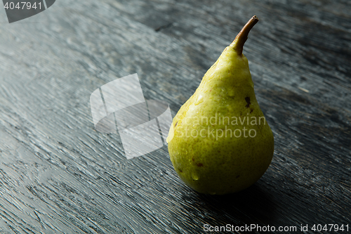 Image of Green pear on a dark background