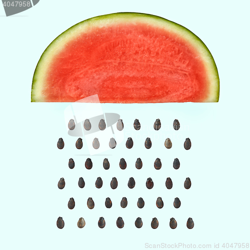 Image of Watermelon slice with seeds raining.