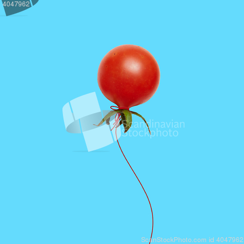 Image of red tomato balloon flying