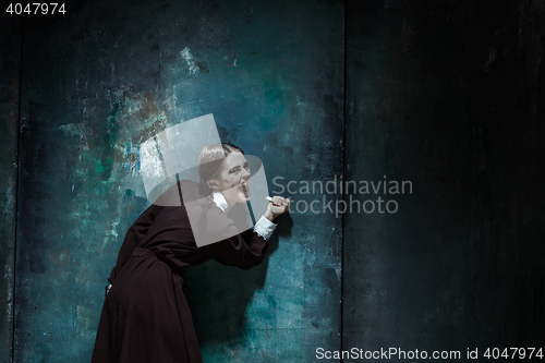 Image of Portrait of a young smiling girl in school uniform as killer woman