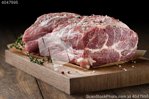 Image of Photo of raw meat. Pork neck with herbs