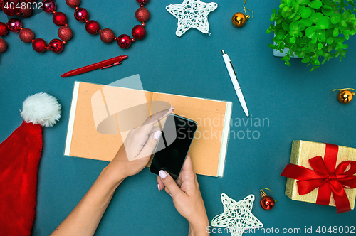 Image of The famale hands with Christmas decorations.