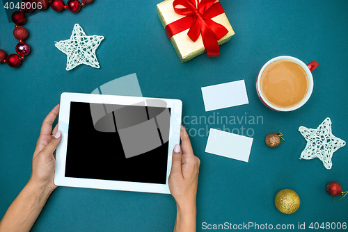 Image of The famale hands with Christmas decorations.