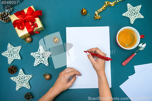 Image of The famale hands with Christmas decorations.