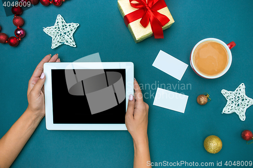 Image of The famale hands with Christmas decorations.