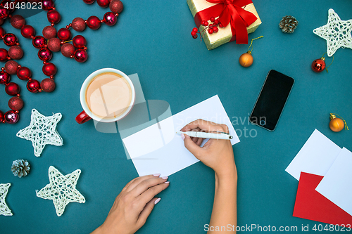 Image of The famale hands with Christmas decorations.