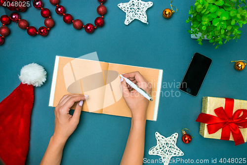 Image of The famale hands with Christmas decorations.