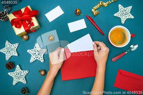 Image of The famale hands with Christmas decorations.