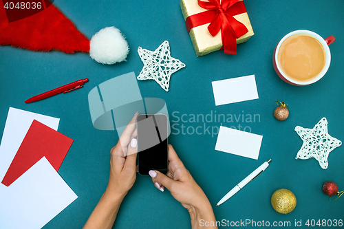 Image of The famale hands with Christmas decorations.