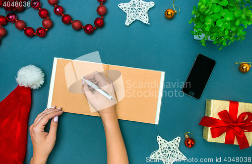 Image of The famale hands with Christmas decorations.