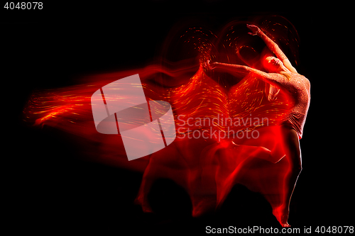 Image of Fine art portrait of beautiful woman dancer in red sparkles