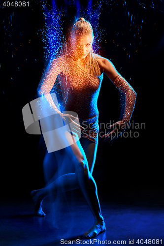 Image of Fine art portrait of beautiful woman dancer in blue sparkles