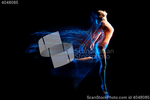 Image of Fine art portrait of beautiful woman dancer in blue sparkles