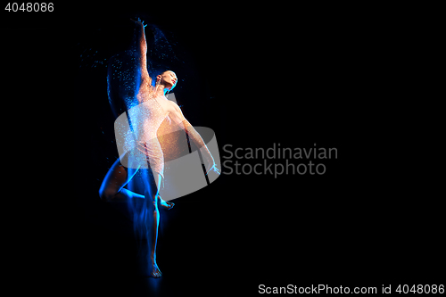 Image of Fine art portrait of beautiful woman dancer in blue sparkles