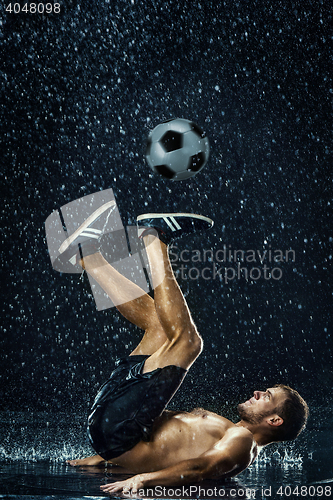 Image of Water drops around football player under water