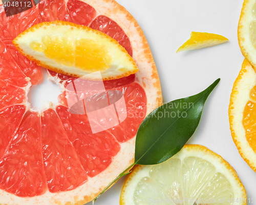 Image of Background of citrus fruit slices, with lemons, oranges and grapefruit