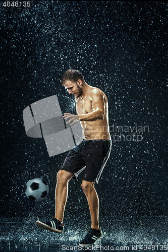 Image of Water drops around football player under water