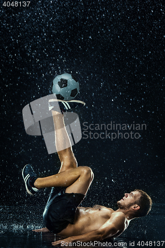 Image of Water drops around football player under water