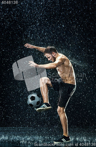 Image of Water drops around football player under water