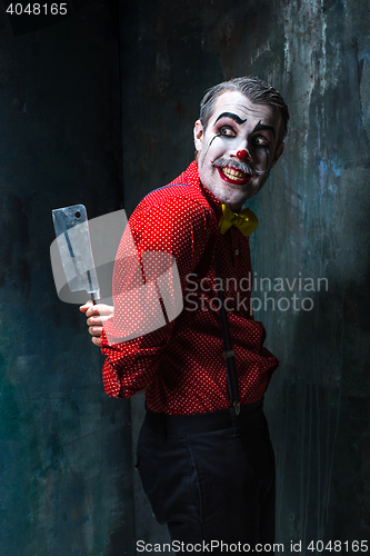 Image of The crazy clown holding a knife on dack. Halloween concept