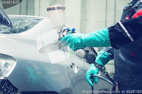 Image of painting a car