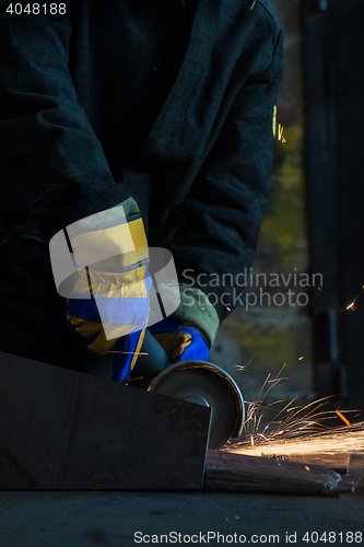 Image of worker welding metal