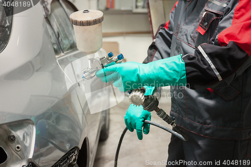 Image of painting a car