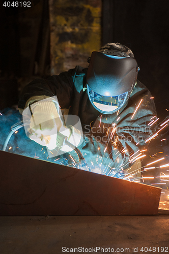 Image of worker welding metal