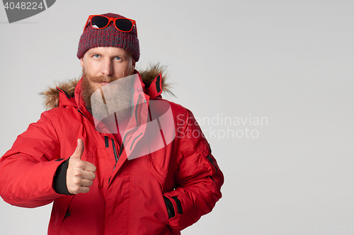 Image of Serious bearded man showing thumb up