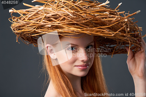 Image of Smiling beautiful woman in natural wreath