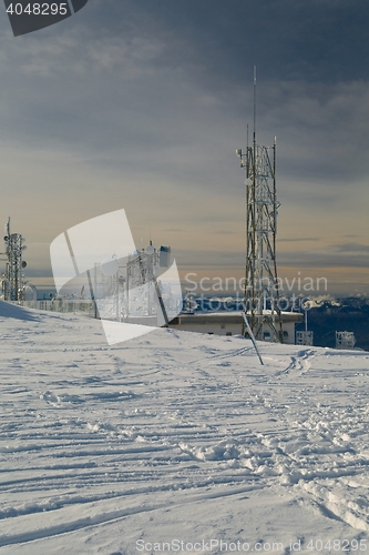 Image of Transmitter towers on a hill in winter