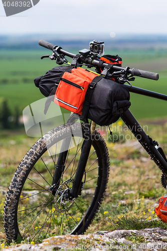 Image of Bicycle with orange bags for travel