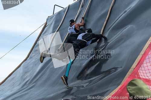 Image of Sportsman storms big wall in extrim race. Tyumen