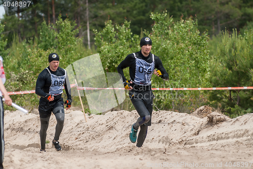 Image of Sportsmen run between stages in extrim race.Tyumen