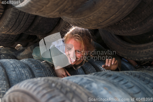 Image of Girl moves between old tires. Tyumen