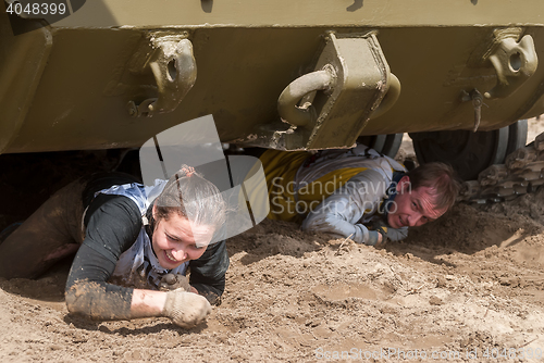 Image of Racers move under tank in extrim race. Tyumen