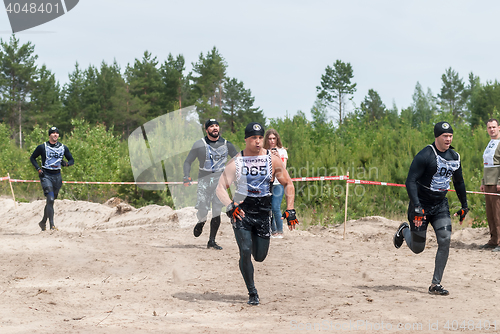 Image of Sportsmen run between stages in extrim race.Tyumen