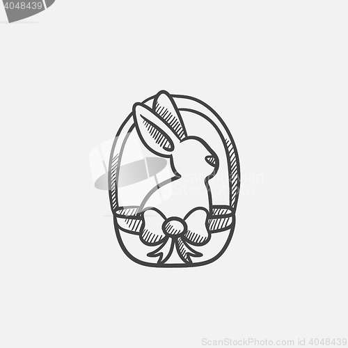 Image of Easter bunny sitting in basket sketch icon.